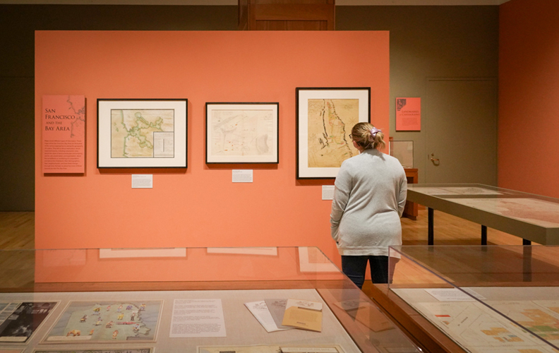 A visitor looks at SF maps